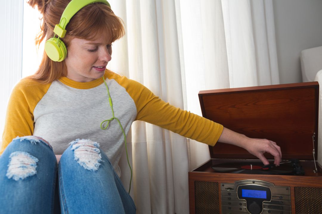 Woman listening to music on gramophone - Free Images, Stock Photos and Pictures on Pikwizard.com