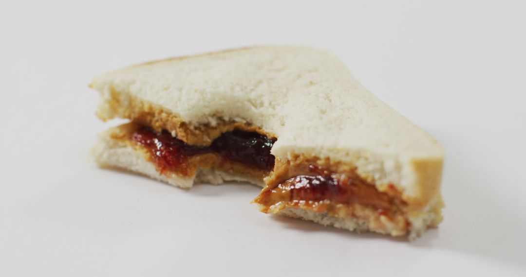 Image of peanut butter and jelly sandwich on a white surface - Free Images, Stock Photos and Pictures on Pikwizard.com