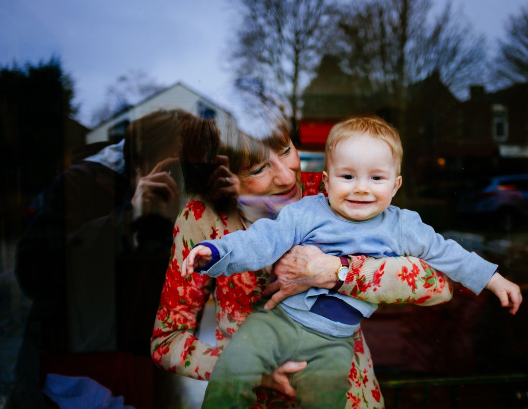 a woman holding a baby - Free Images, Stock Photos and Pictures on Pikwizard.com
