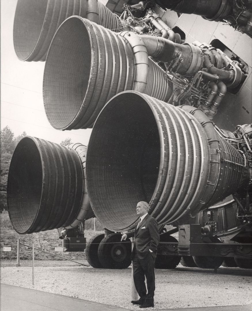 a man standing next to a large rocket - Free Images, Stock Photos and Pictures on Pikwizard.com