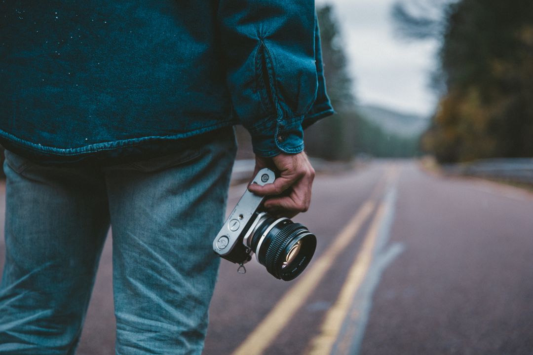 Image of A Person Holding a Camera in One hand
