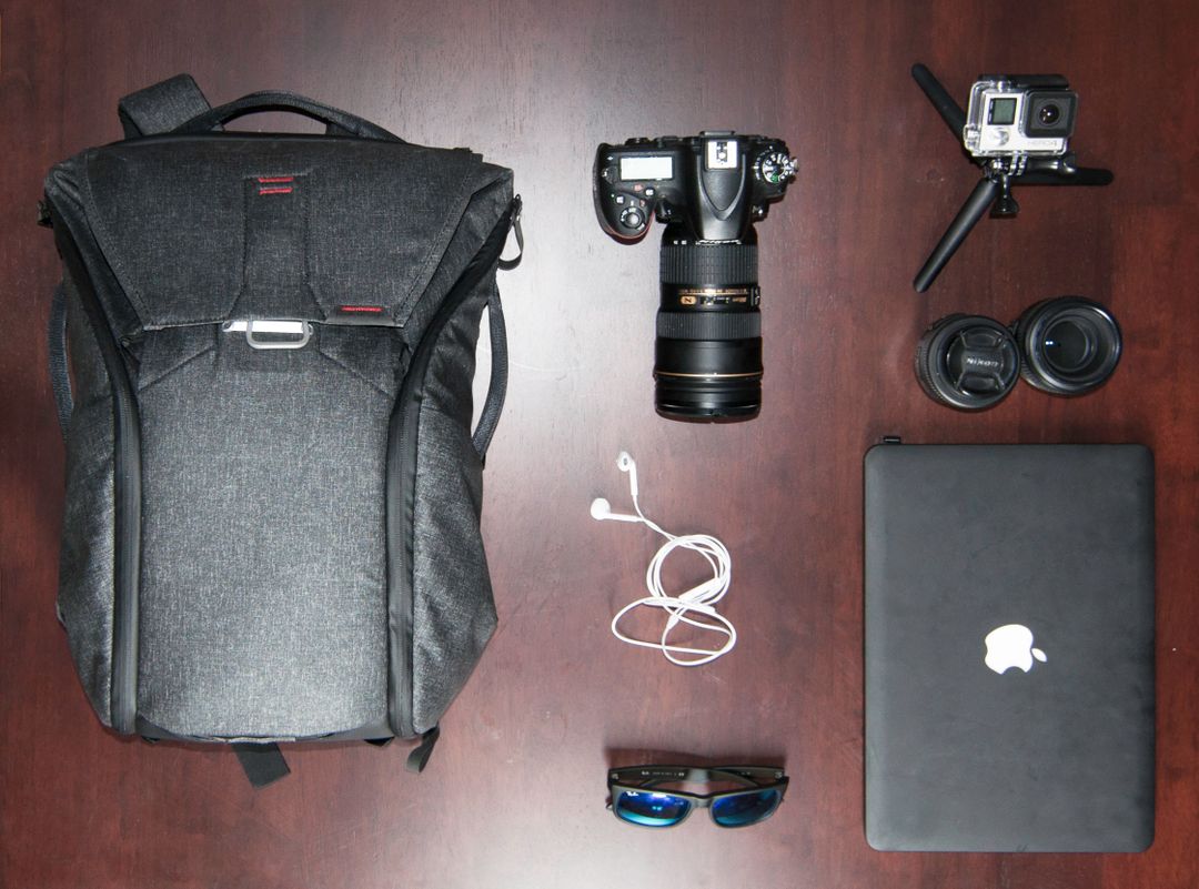 Overhead image of photography equipment, sunglasses and earphones