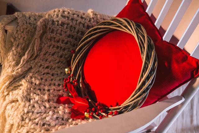 Grapevine wreath with red pillow on chair - Download Free Stock Photos Pikwizard.com