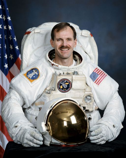 Official portrait of Astronaut Steve Smith wearing an EMU - Download Free Stock Photos Pikwizard.com