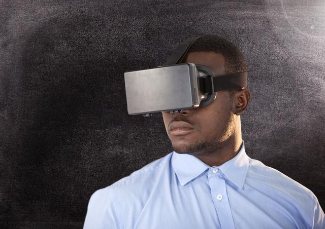 Man using virtual reality headset against grey background - Download Free Stock Photos Pikwizard.com
