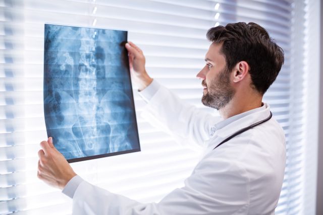 Male doctor examining x-ray - Download Free Stock Photos Pikwizard.com