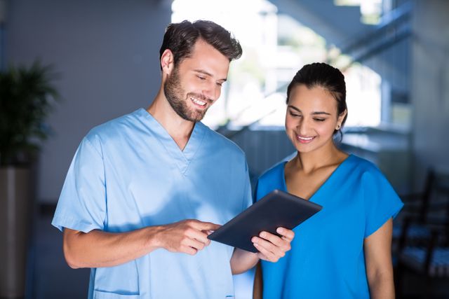 Doctors using digital tablet in hospital