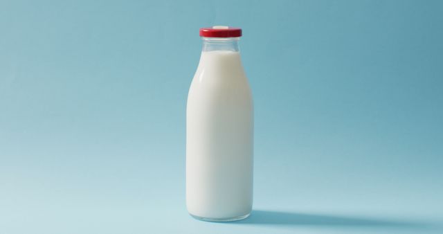Image of glass bottle of milk on blue background - Download Free Stock Photos Pikwizard.com