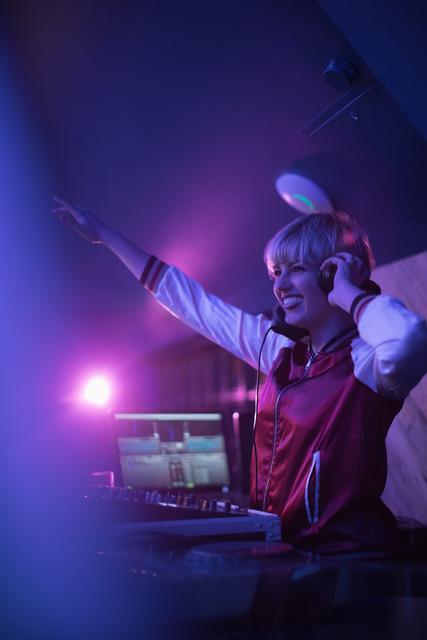 Female dj waving her hand while playing music in bar - Download Free Stock Photos Pikwizard.com