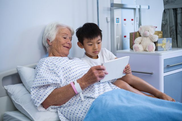 Senior patient and boy holding digital tablet - Download Free Stock Photos Pikwizard.com