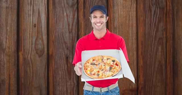 Happy delivery man showing fresh pizza - Download Free Stock Photos Pikwizard.com