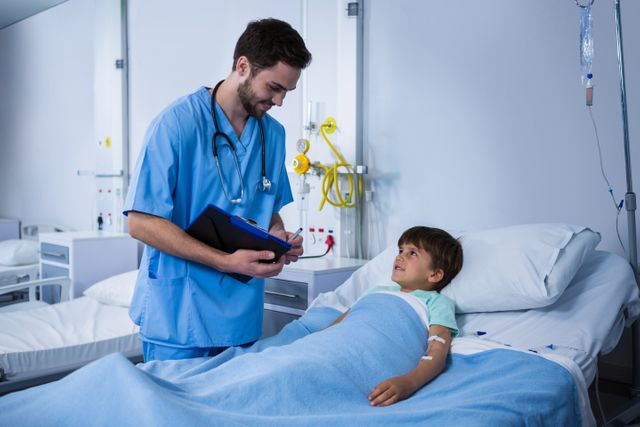 Male nurse interacting with patient during visit in ward - Download Free Stock Photos Pikwizard.com