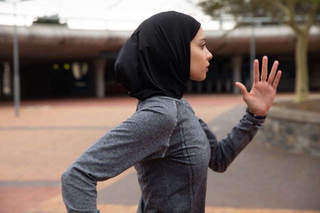 Woman in hijab running in urban park - Download Free Stock Photos Pikwizard.com