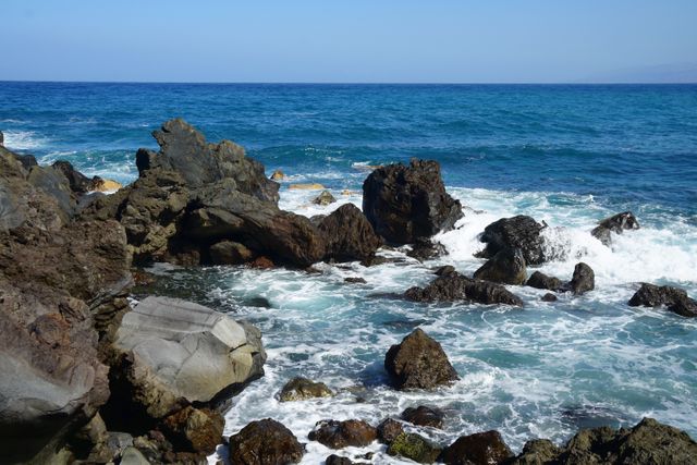 Blue water ocean rocky beach volcanic rocks - Download Free Stock Photos Pikwizard.com