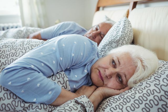 Senior woman awake on bed - Download Free Stock Photos Pikwizard.com