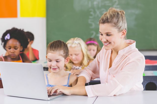 Teacher teaching schoolgirl on laptop - Download Free Stock Photos Pikwizard.com
