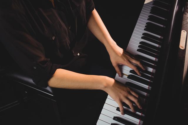 Mid-section of female student playing piano - Download Free Stock Photos Pikwizard.com