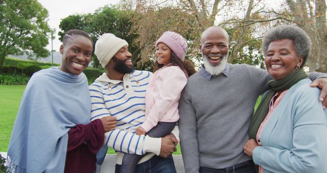 Image of happy african american parents holding daughter in garden with grandparents. Family, domestic life and togetherness concept digitally generated image.