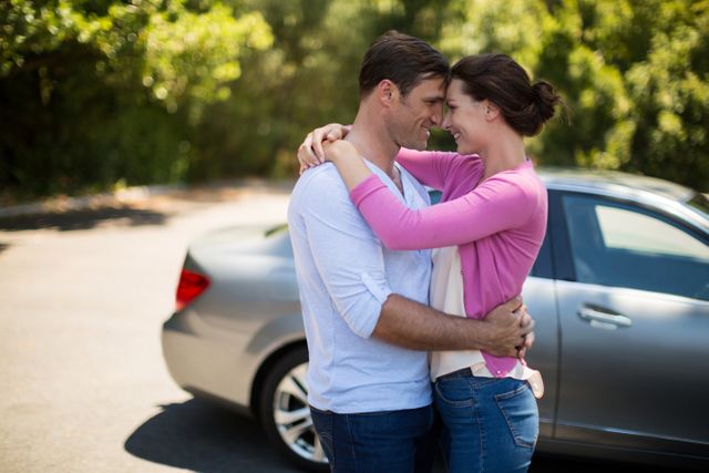 Couple embracing by car on sunny day - Download Free Stock Photos Pikwizard.com