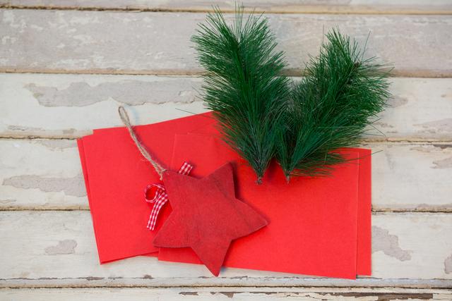Red envelopes, christmas fir and star on wooden plank - Download Free Stock Photos Pikwizard.com