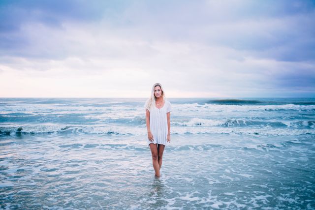 Woman in Standing Body of Water While Wearing White Scoop Neck Top - Download Free Stock Photos Pikwizard.com