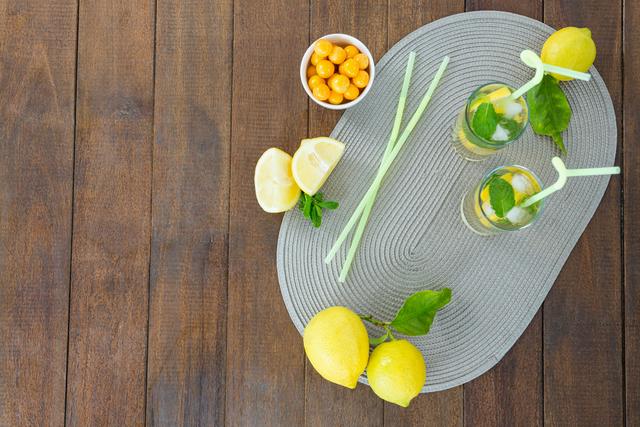 Glass of mojito cocktail, lemon and yellow cherries - Download Free Stock Photos Pikwizard.com