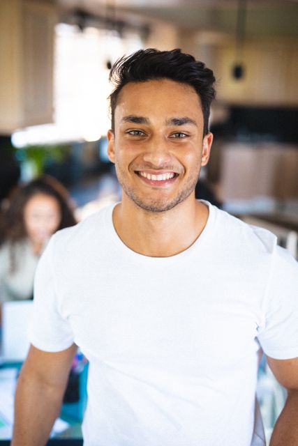 Portrait of smiling handsome young biracial man standing at home - Download Free Stock Photos Pikwizard.com
