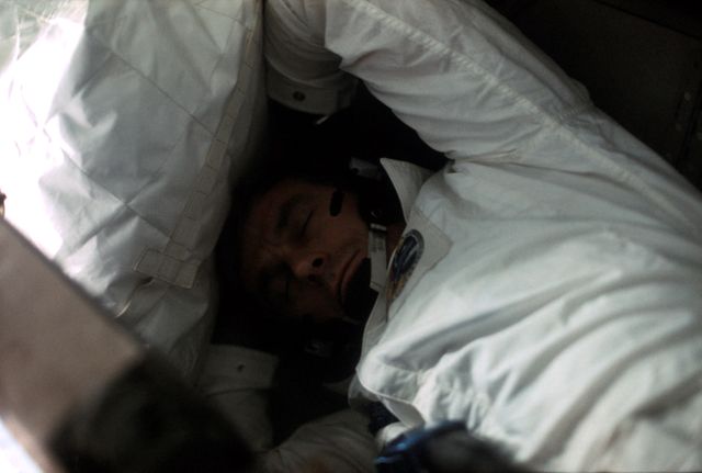 AS17-162-24049 (7-19 Dec. 1972) --- A fellow crewman took this picture of astronaut Eugene A. Cernan dozing aboard the Apollo 17 spacecraft during the final lunar landing mission in NASA's Apollo program. Also, aboard Apollo 17 were astronaut Ronald E. Evans, command module pilot, and scientist-astronaut Harrison H. "Jack" Schmitt, lunar module pilot. Cernan was the mission commander.