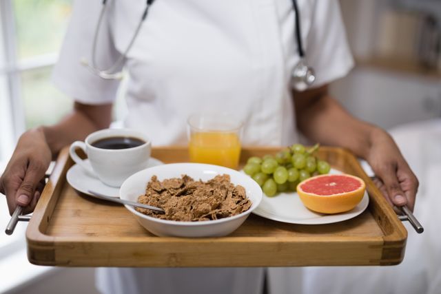 Mid section of nurse holding breakfast tray - Download Free Stock Photos Pikwizard.com