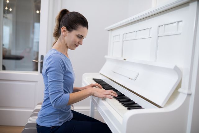 Beautiful woman playing piano - Download Free Stock Photos Pikwizard.com