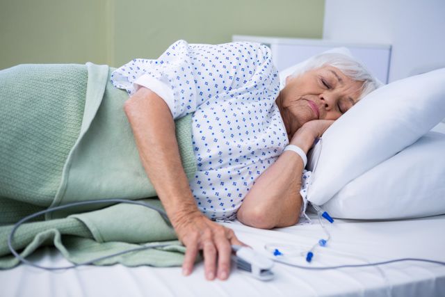 Senior patient lying on bed in hospital
