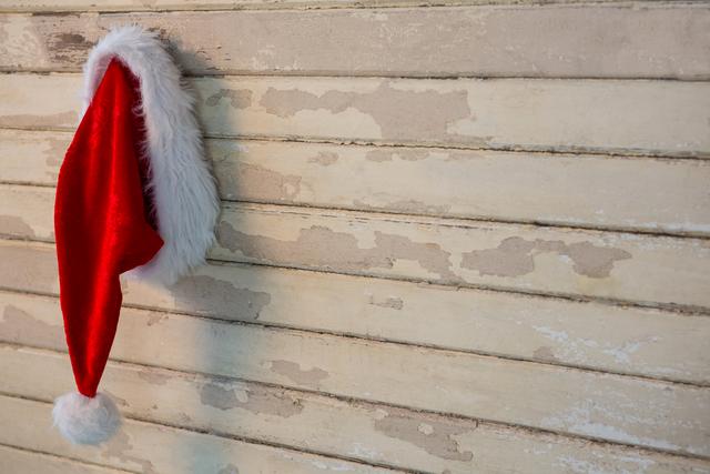 Santa hat hanging wooden wall - Download Free Stock Photos Pikwizard.com