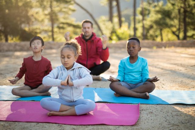 Coach and kids meditating in park - Download Free Stock Photos Pikwizard.com