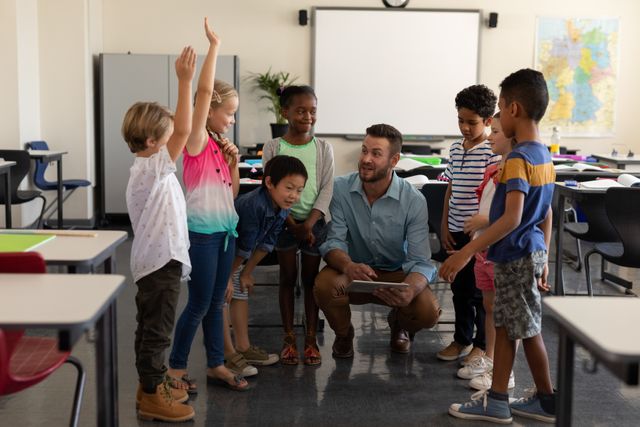 School kids raising hands while teacher teaching - Download Free Stock Photos Pikwizard.com