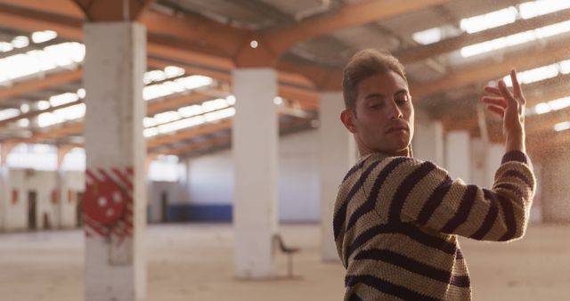 Caucasian male dancer dancing in abandoned sunny warehouse, copy space - Download Free Stock Photos Pikwizard.com
