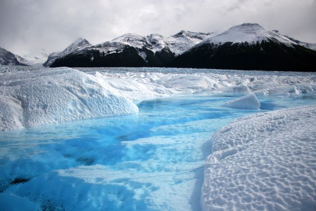 a glacier with blue water - Download Free Stock Photos Pikwizard.com