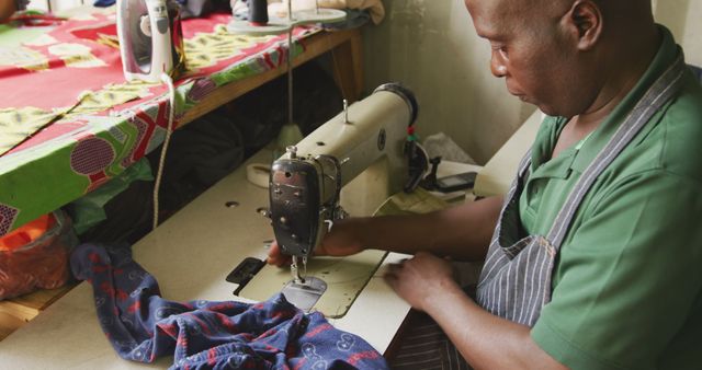 African american male tailor using sewing machine in workshop - Download Free Stock Photos Pikwizard.com