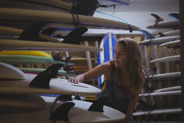 Woman selecting a surfboard - Download Free Stock Photos Pikwizard.com