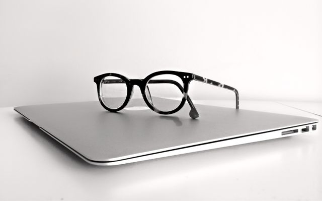 Black Frame Eyeglasses on Silver Macbook Air - Download Free Stock Photos Pikwizard.com