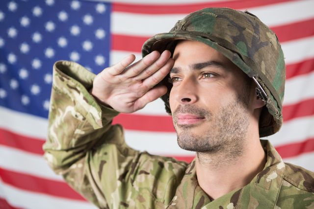 Confident soldier saluting against american flag