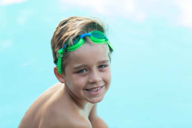 Smiling little boy wearing green swimming goggles - Download Free Stock Photos Pikwizard.com