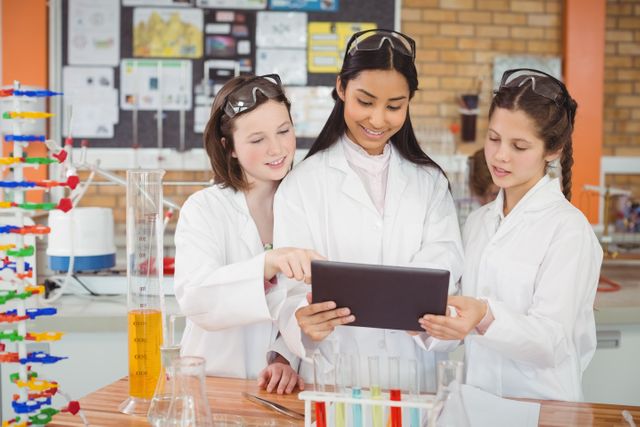 School girls using digital tablet in laboratory - Download Free Stock Photos Pikwizard.com