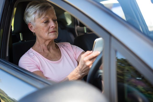 Senior woman using mobile phone while driving car - Download Free Stock Photos Pikwizard.com