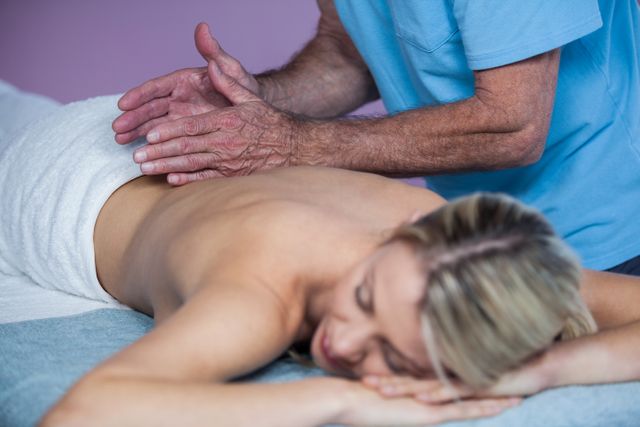 Woman receiving back massage from physiotherapist - Download Free Stock Photos Pikwizard.com