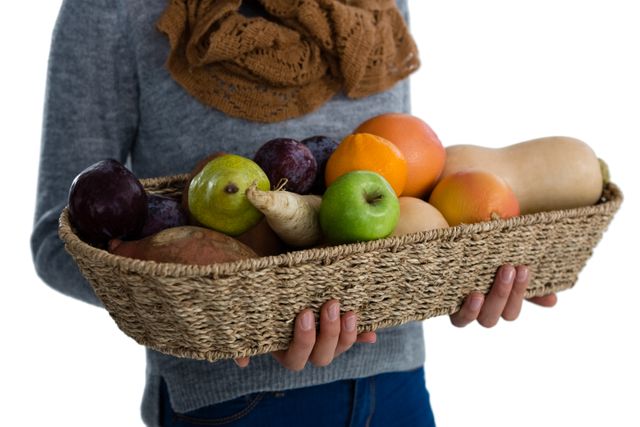Mid section of woman carrying vegetables and fruits in wicker basket - Download Free Stock Photos Pikwizard.com