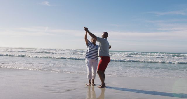 Senior african american couple dancing at the beach - Download Free Stock Photos Pikwizard.com