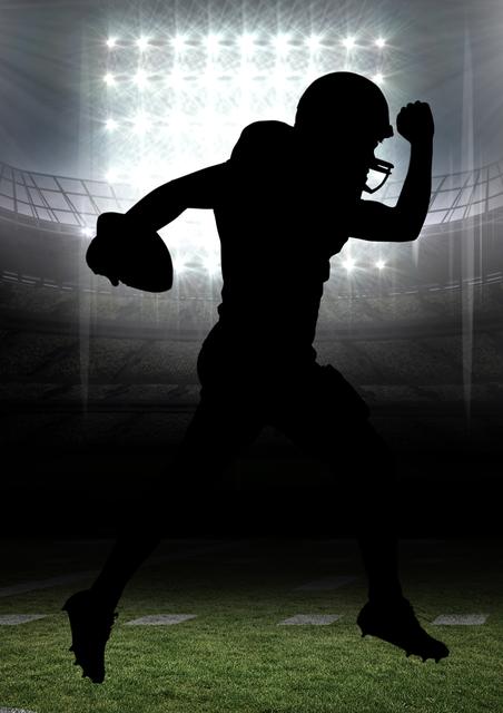 Silhouette of american football player running with a ball in stadium - Download Free Stock Photos Pikwizard.com