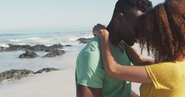 Happy biracial couple hugging and kissing on beach - Download Free Stock Photos Pikwizard.com
