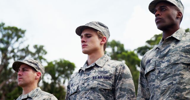 Three solemn Air Force members embody dedication and discipline in ...