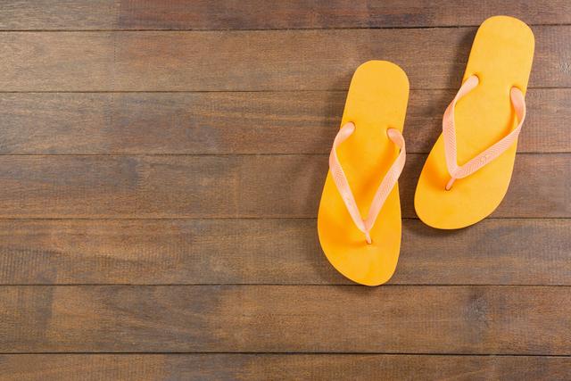 Pair of yellow beach flip flop slipper - Download Free Stock Photos Pikwizard.com